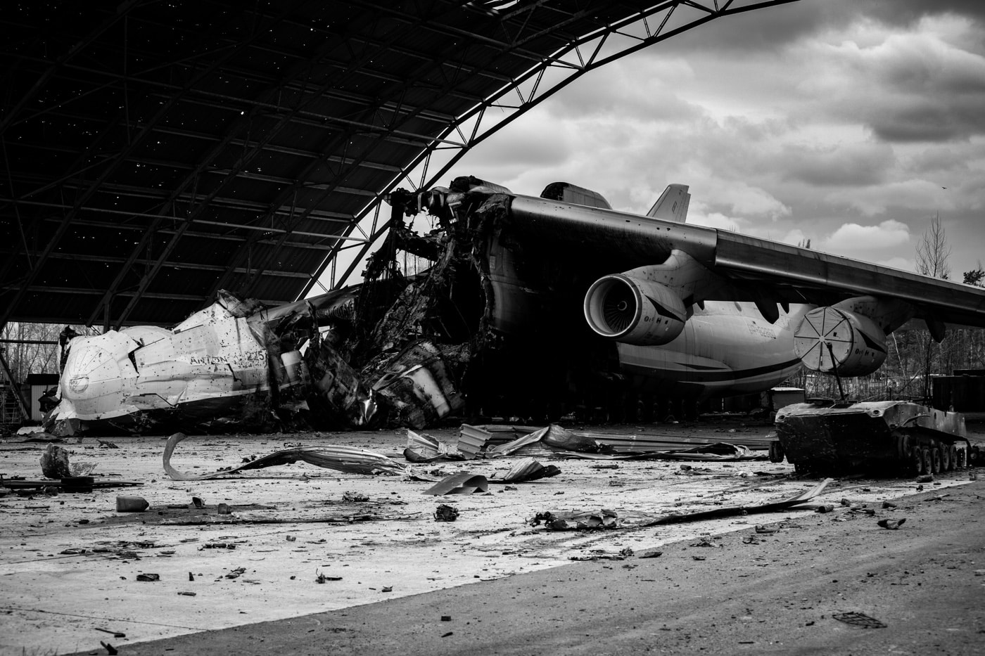 In this black and white photograph, we see the unique Antonov An-225 plane that was destroyed during the fighting. It was the only aircraft of its design that was ever completely built. 