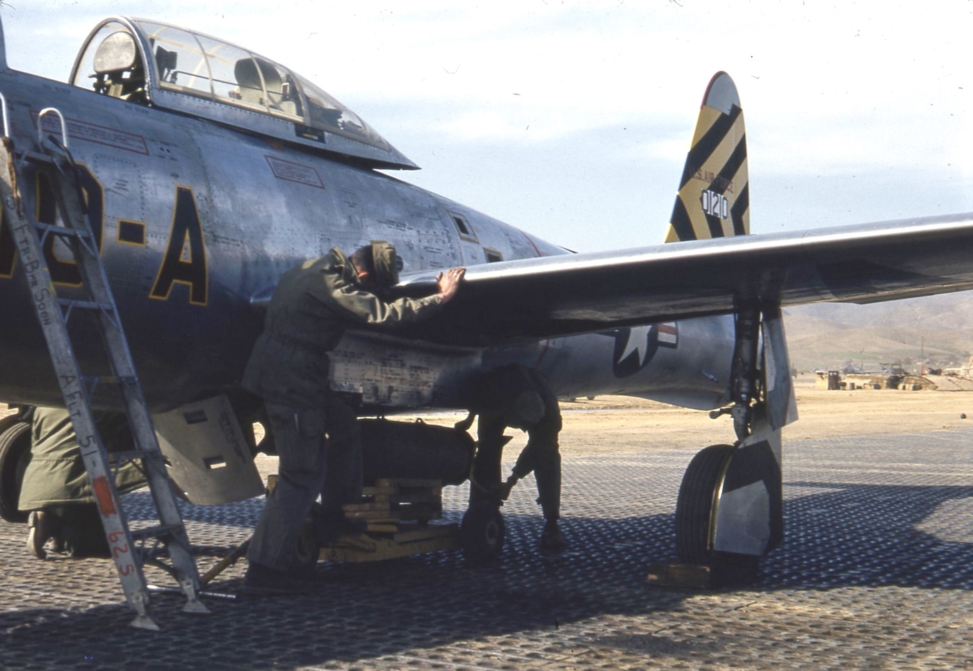 loading a bomb on an F-84 during the Korean War