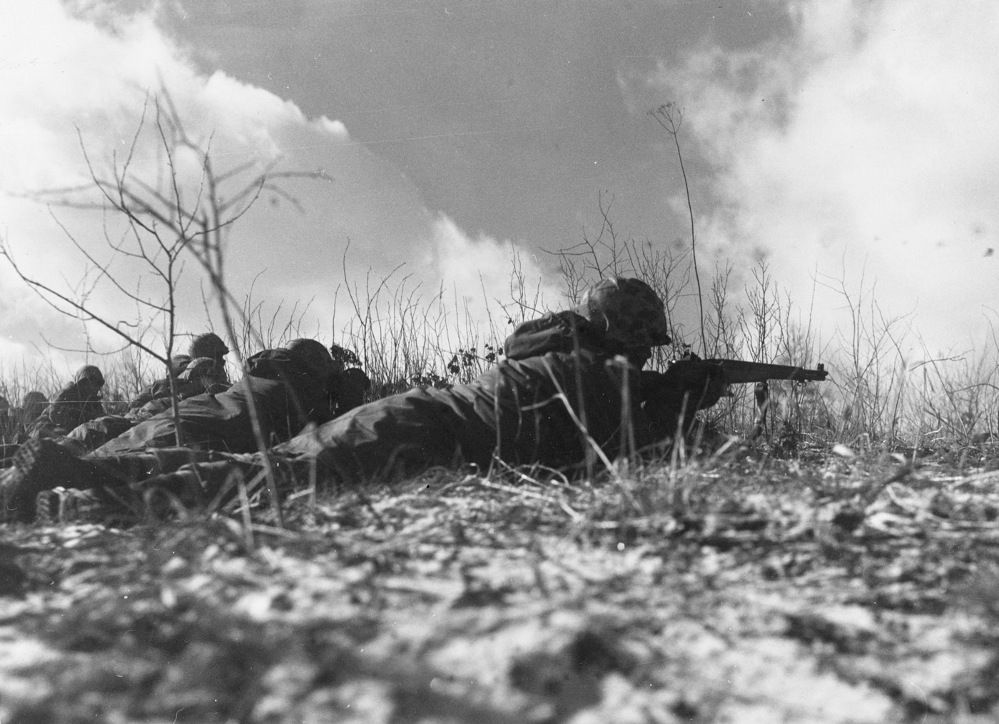 In this photo, we see Marines engage Chinese forces with M1 Garand rifles along a ridge.