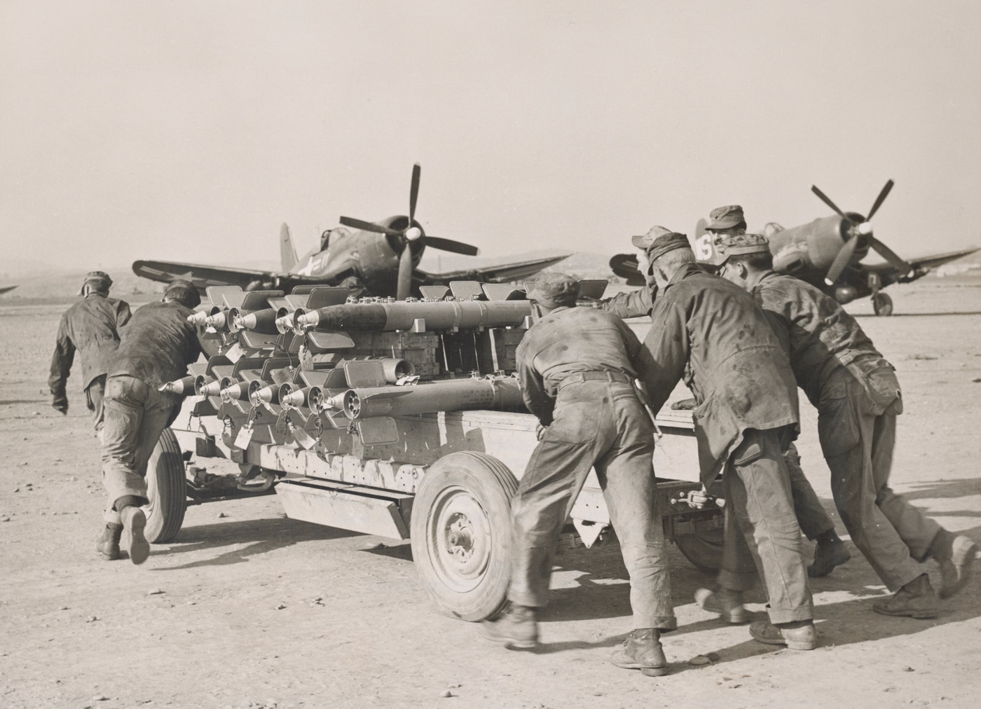 crew loads F4U Corsair night fighter with rockets during Korean War