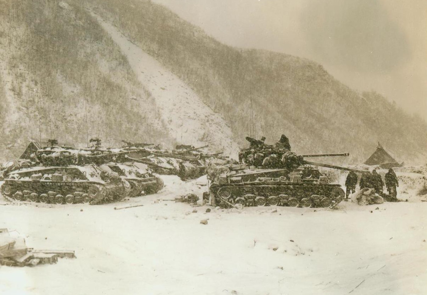 In this image, we see American tanks sitting in the snow on the perimeter of Koto-ri in December 1950.