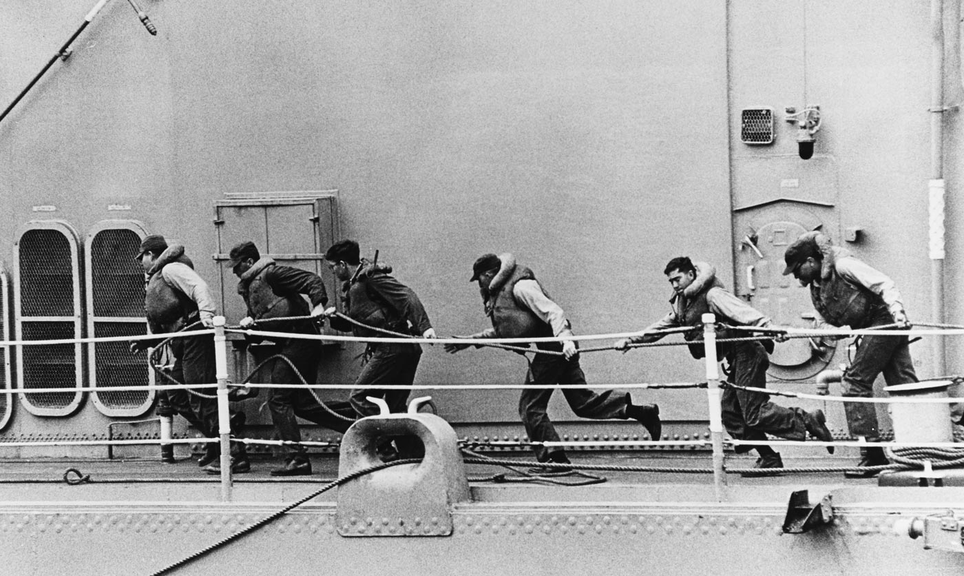 sailors on USS Long Beach haul in the high line in the South China Sea