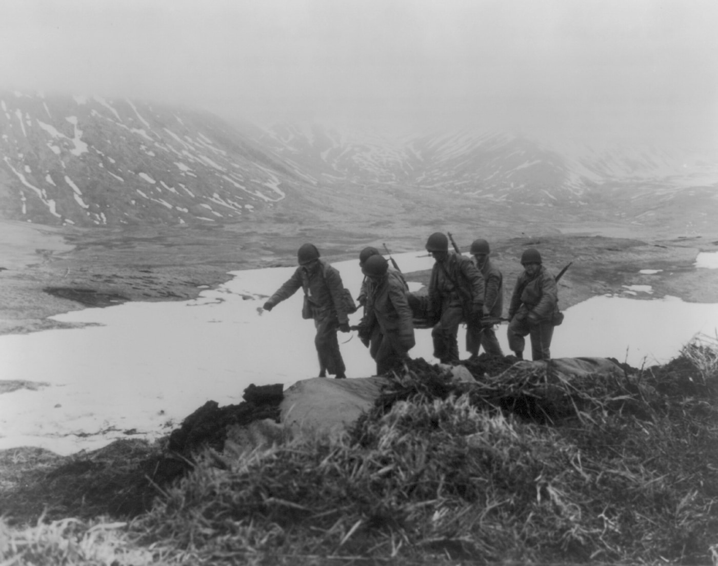 American soldiers carry a wounded man on a stretcher