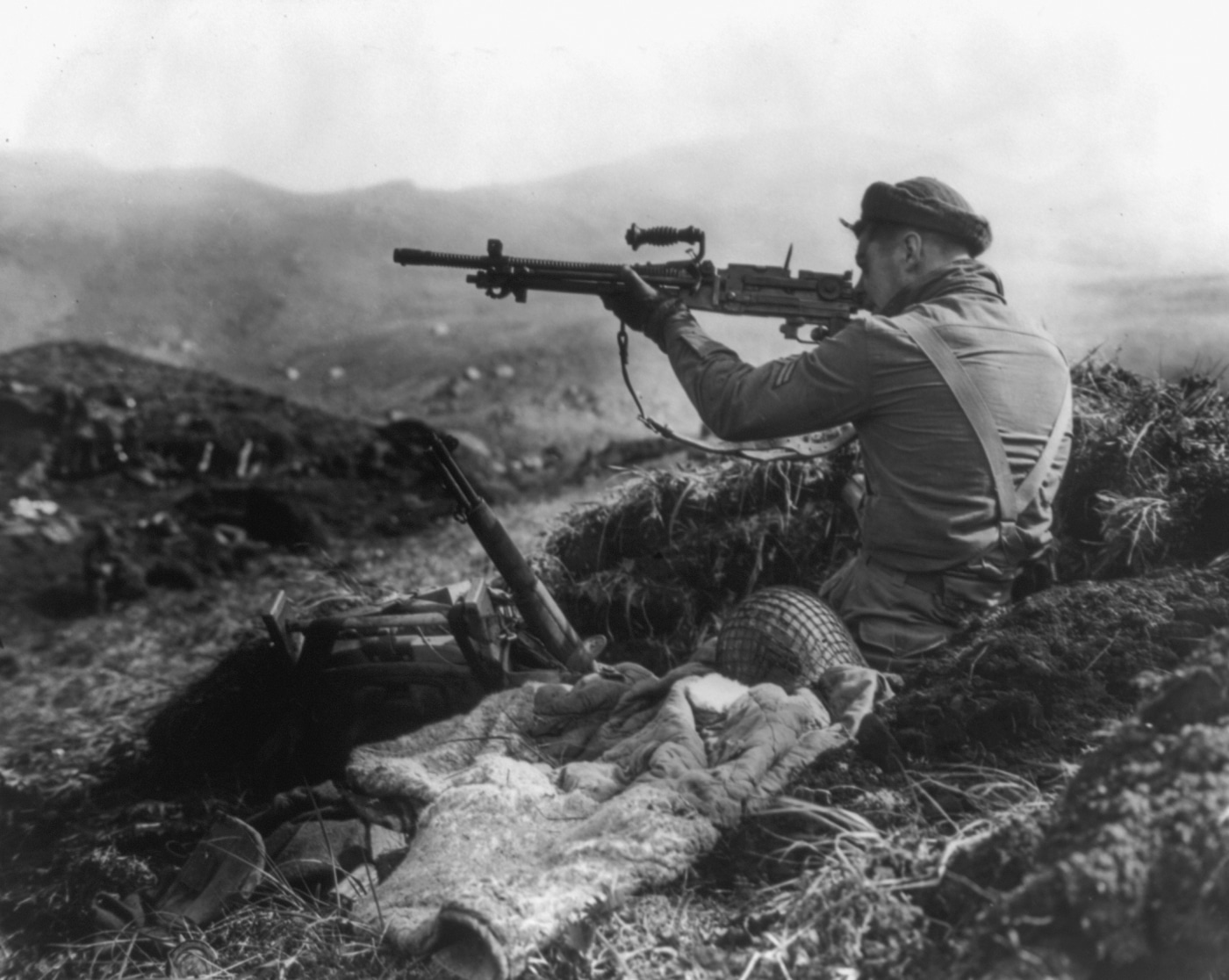 Canadian soldier fires Japanese Type 96 machine gun on Kiska Island