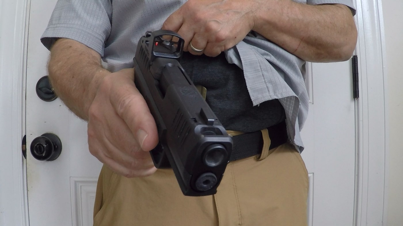 Image of a ported pistol on a bench with a row of empty casings behind it. The background suggests a recently completed range session. The photo supports the idea that properly built comped pistols can run reliably without frequent failures. Helps rebut the myth that ported guns are more prone to jamming.
