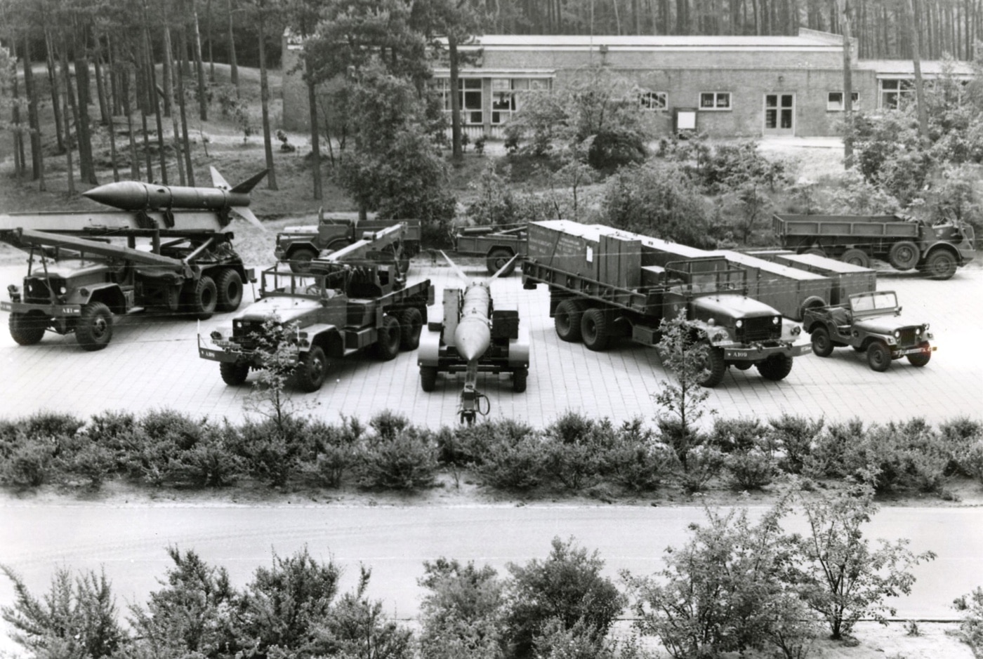 Honest John unit with M386 truck rocket launcher M62 5-ton wrecker M329 rocket transport trailer M78A1