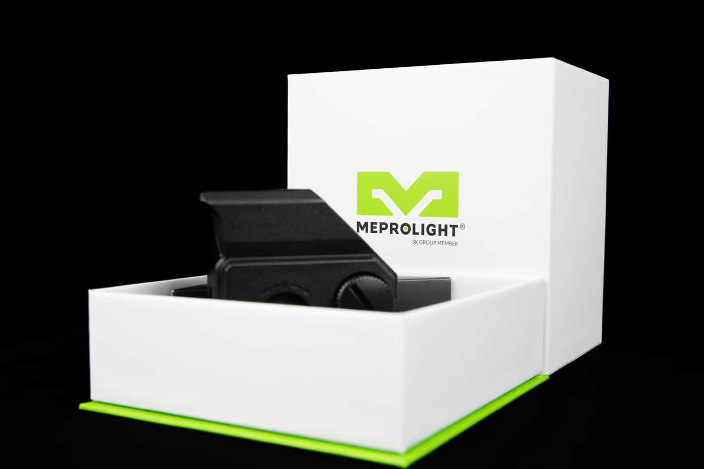 Box contents of the Meprolight Tru-Vision SR laid out on a bench. Includes optic, neoprene cover, CR123 battery, manual, lens cloth, and a small brush. Packaging is foam-lined and durable, showing attention to detail. The kit is ready to mount out of the box. Image illustrates everything that ships with the optic.