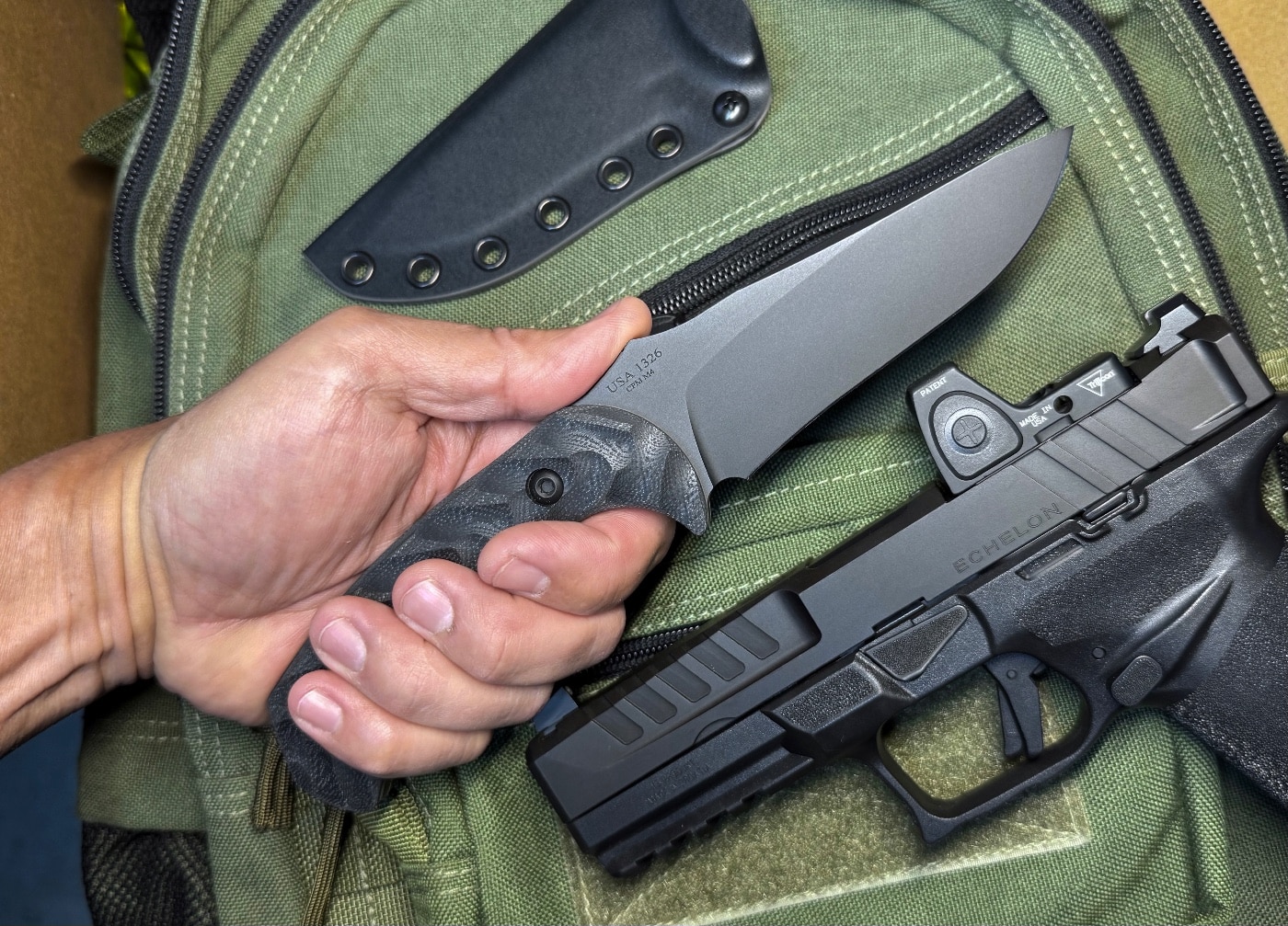 Close-up image of the Toor Knives Mullet S fixed blade knife in SOCOM Black. The blade features a CPM M4 steel construction with a proprietary Gunkote coating. The knife includes a full tang build with black G10 handles that have dynamic fluting. The profile shows a drop point with a slight recurve, optimized for cutting and thrusting. This tactical knife is shown clean and unused, illustrating the premium finish of Toor Knives.