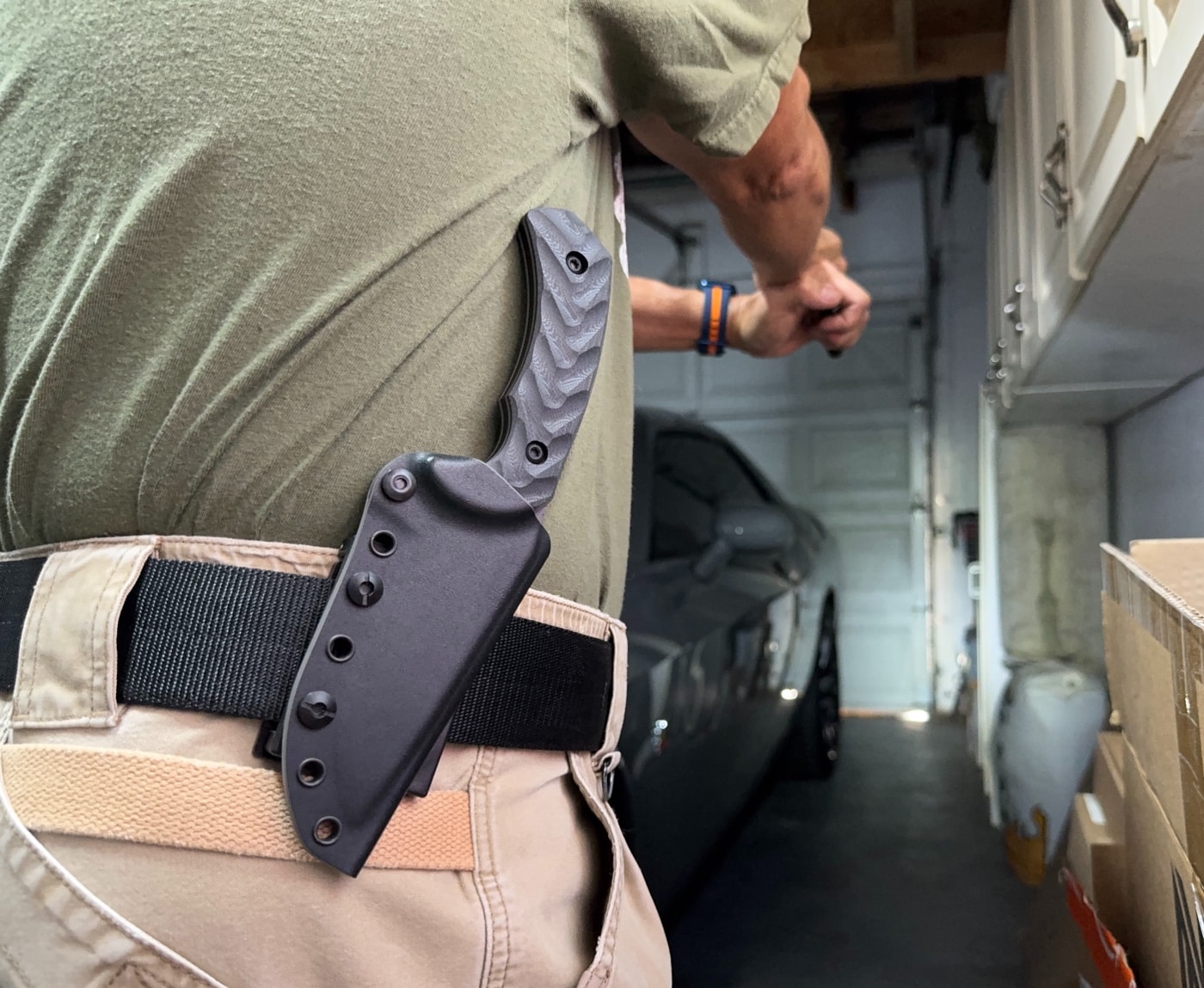 Detailed view of the Toor Knives Mullet S FlexTech Kydex sheath, black exterior with a grey interior. The sheath features tension adjustment, six reinforced grommets, and is lined with a soft inner cloth for blade protection. Designed for horizontal, scout, or MOLLE-compatible carry setups. The sheath reflects the same thoughtful construction as the knife itself. This sheath is part of what makes the Mullet an ideal EDC fixed blade or tactical companion.