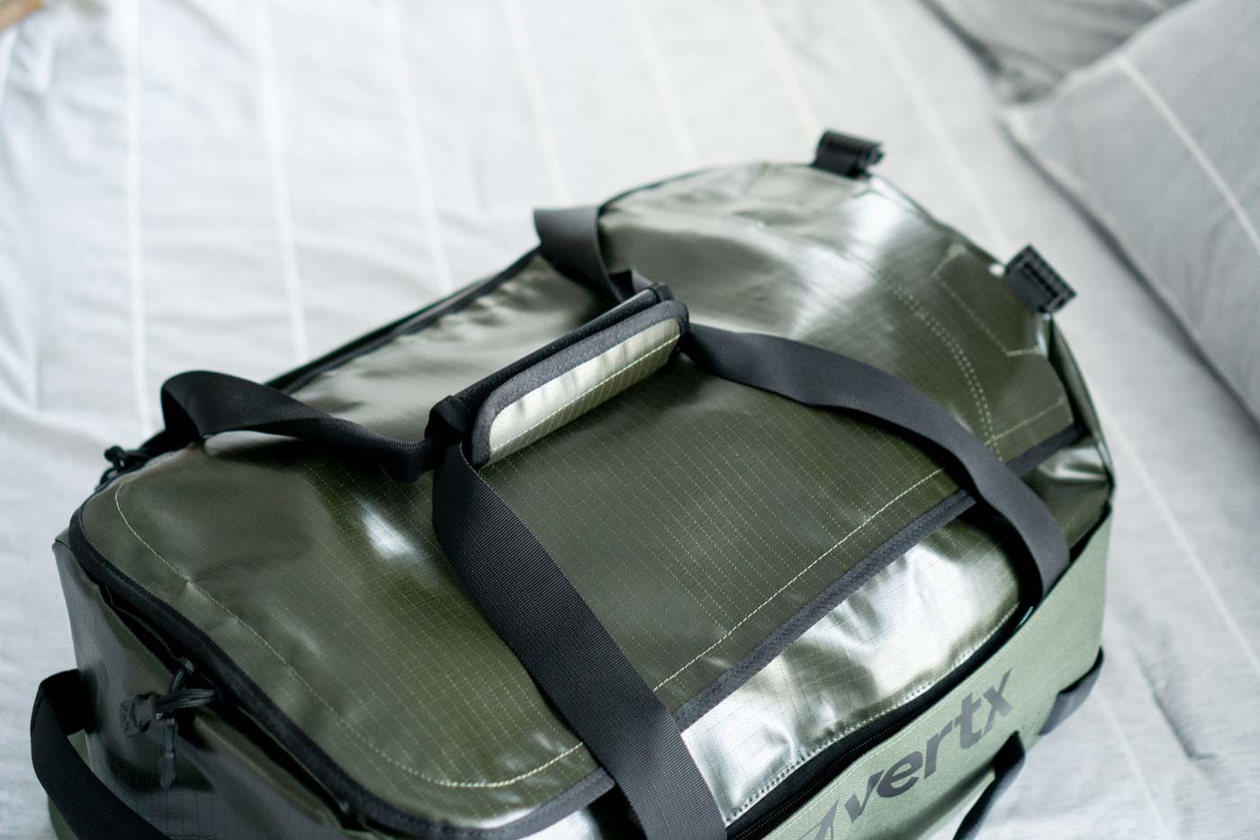 Close-up detail of the polyurethane-coated ripstop fabric used in the construction of the Vertx RLT 50L Duffel Bag. The tactical bag's water-resistant material features a distinctive ripstop pattern that enhances durability and tear resistance while maintaining a lightweight profile.