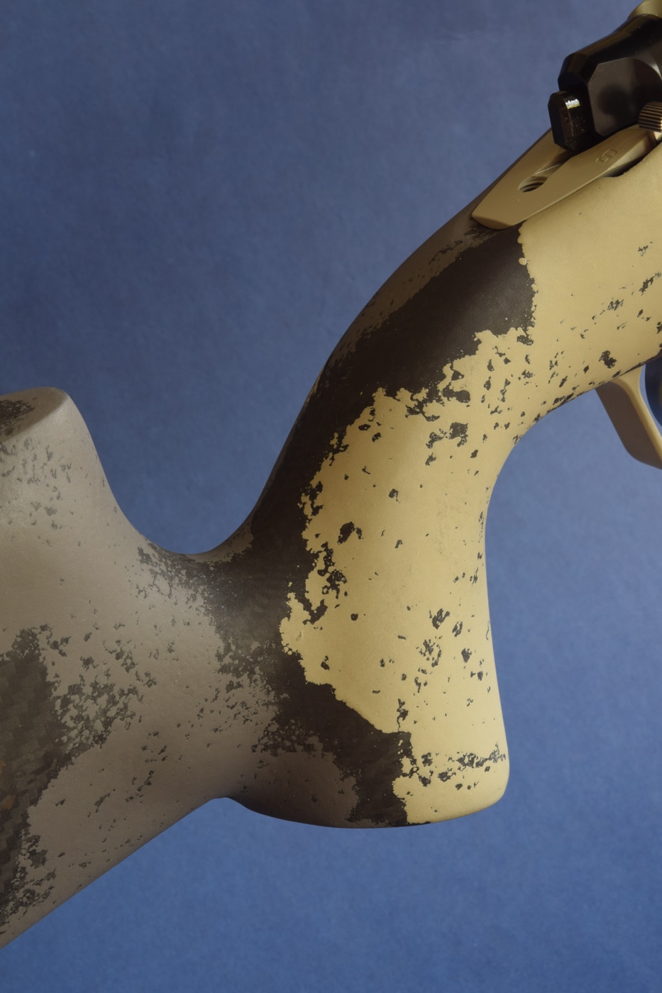 Close-up of the traditional straight grip on the hunting stock of a Springfield Armory Model 2020 Waypoint rifle chambered in .270 Winchester. The palm swell and gentle shelf cradle the shooter’s hand for natural trigger-finger placement. The carbon-fiber–reinforced stock shows subtle checkering and contouring to ensure a solid hold in damp or cold conditions. The moderate grip angle balances classic hunting ergonomics with precision control for follow-up shots. This ergonomic design complements the .270 Winchester’s flat trajectory and high muzzle velocity, helping manage the cartridge’s 17 ft-lb recoil impulse. Pillar bedding locks the action in place to harness the round’s downrange energy and high sectional density. The overall feel inspires confidence in consistent, half-minute accuracy with each shot.