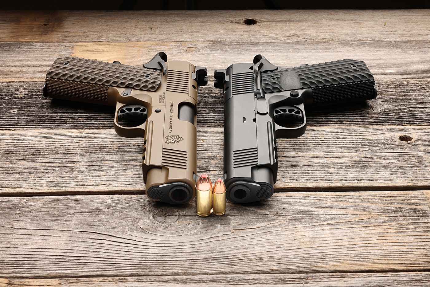 Two Springfield Armory 1911 pistols displayed side by side. One is chambered for 9x19mm Parabellum, known for higher capacity and lower recoil in smaller calibers. The other pistol is chambered for .45 ACP, recognized for its larger projectile and potential stopping power. Both pistols feature identical adjustable iron sights and similar trigger pulls, making them ideal for a direct caliber performance comparison. They are similarly weighted, allowing for an unbiased test of shooting capability between the two calibers. The comparison highlights the ongoing debate between the benefits of higher capacity and control versus larger caliber stopping power. This visual aids in understanding the practical differences evaluated in the article.