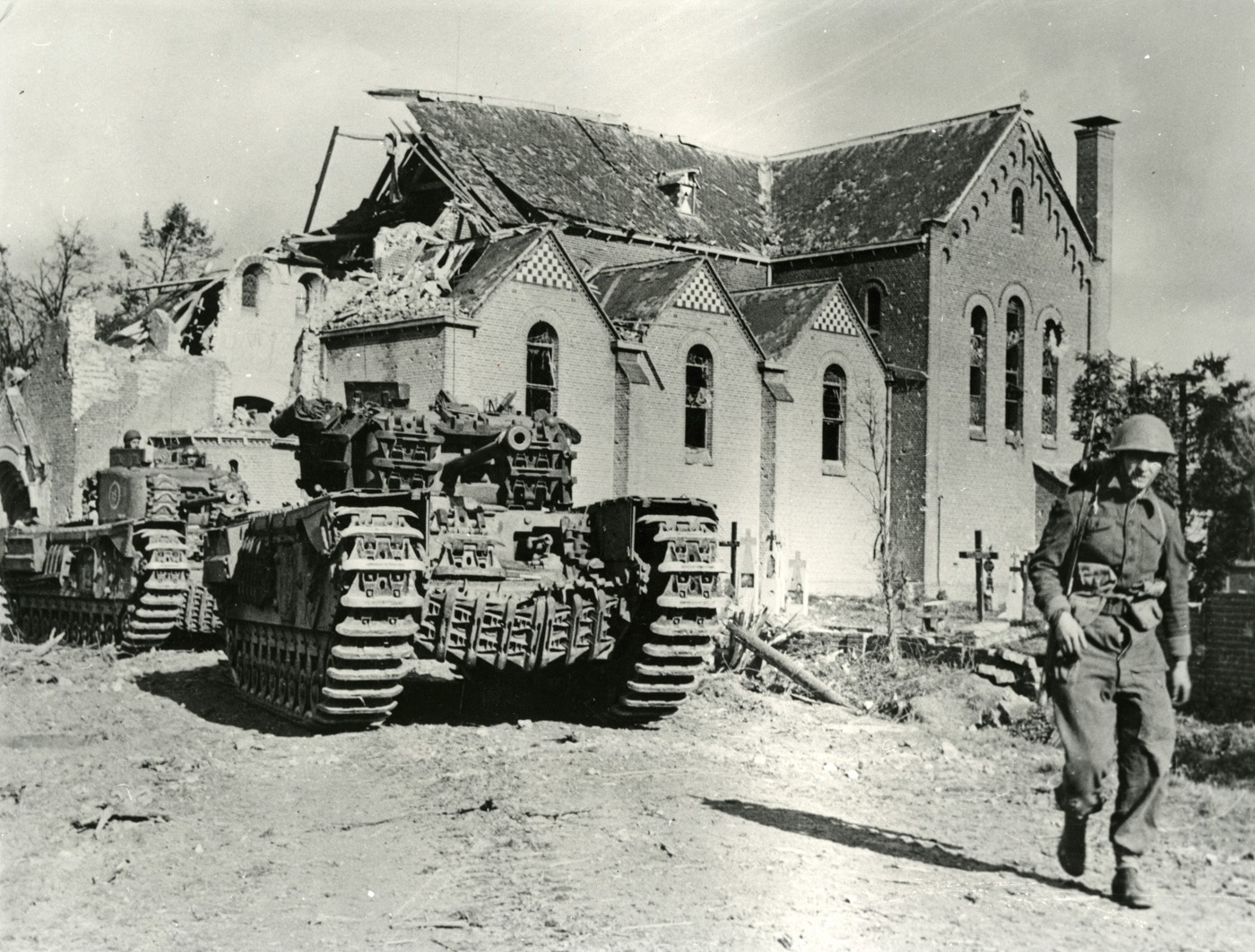British Churchill tanks advance with infantry through Overloon