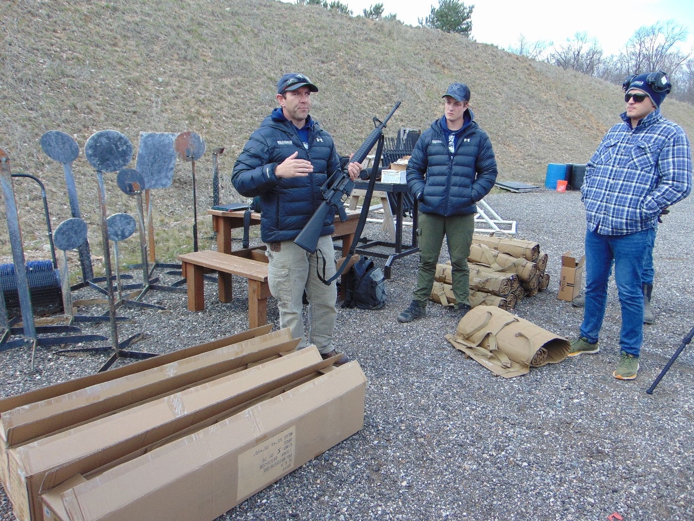 Coach Burlew reviews safety rules on shooting range