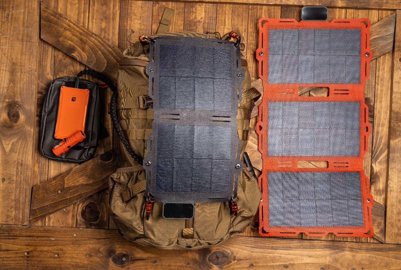 Dark Energy review close-up shows the Spectre solar panel neatly folded and secured inside a backpack side pocket. The collapsible frame and lightweight fabric panel are clearly visible. Its compact size emphasizes weight savings for fastpacking and thru-hiking. You can make out the solar cells’ protected laminate surface and reinforced corner straps. It’s a portable solar charger that packs down small for any backcountry mission.
