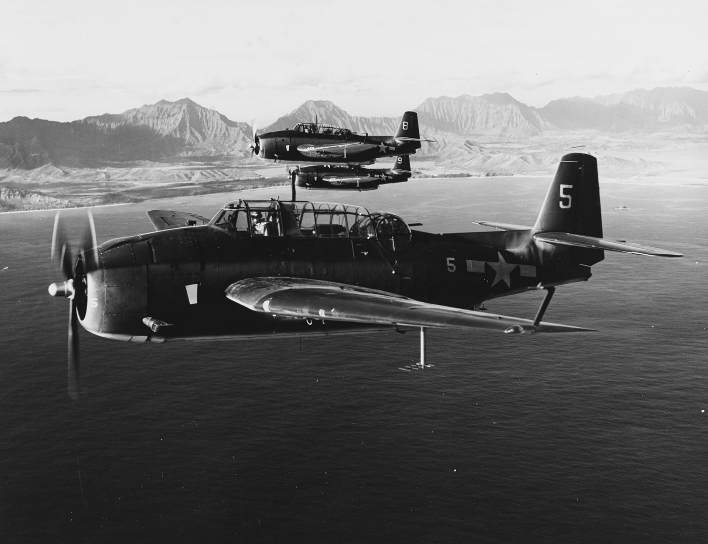 Gruman TBF-1C torpedo bombers from USS Langley fly over Oahu Hawaii 1944