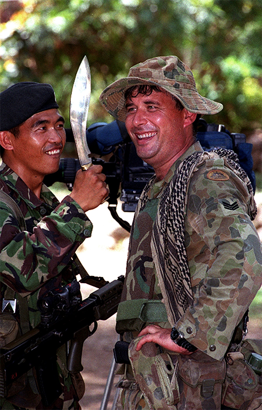Gurkha soldier shows his kukri knife to an Australian soldier during Operation Stabilise in 1999