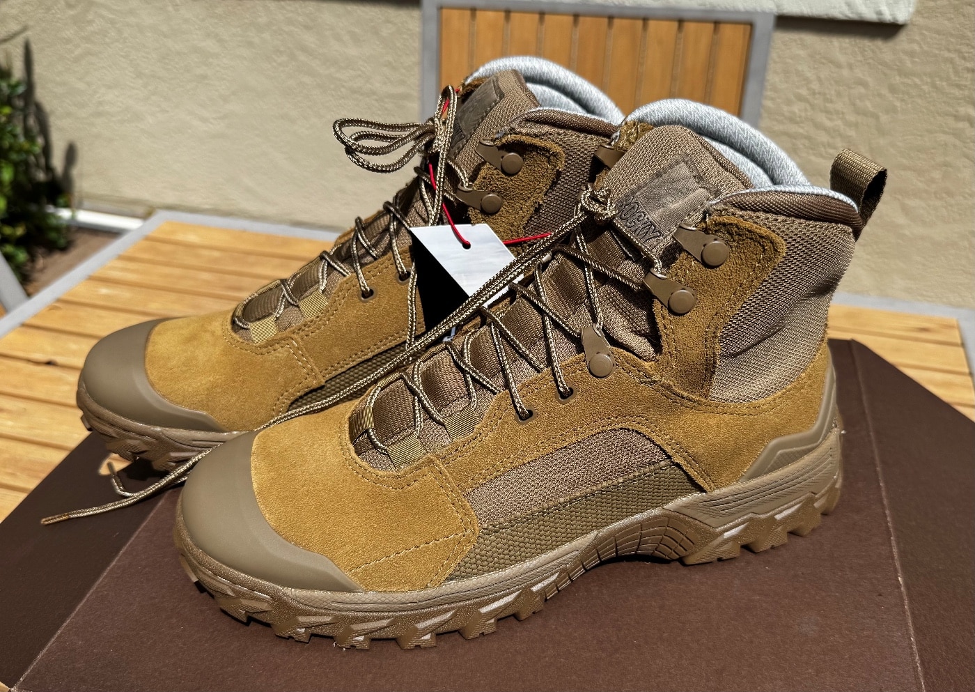 Close-up of the Rocky Mountain Combat Boot’s full-grain leather upper highlighting the tight grain pattern and uniform coyote tan coloration. The leather appears smooth with a slight matte finish, and stitch lines run parallel along the quarter panel. Minor scuffs near the vamp show natural wear after minimal testing. The seams are crisply stitched, with no frayed threads or puckers. This image provides evidence for the Rocky Mountain Combat Boot Review’s comments on upper material quality.