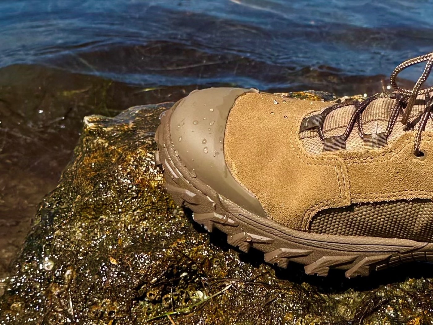 Close-up shot of the Rocky Mountain Combat Boot’s TPU toe cap and integrated heel protector sewn into the outsole. The translucent polyurethane overlay covers the leather where wear usually occurs, offering extra durability. Tiny scuff marks along the TPU edge suggest the boot has been lightly tested in rugged conditions. The leather under the TPU remains unblemished and smooth, indicating proper protective coverage. This detail photo underscores a feature highlighted in the Rocky Mountain Combat Boot Review regarding TPU impact resistance.