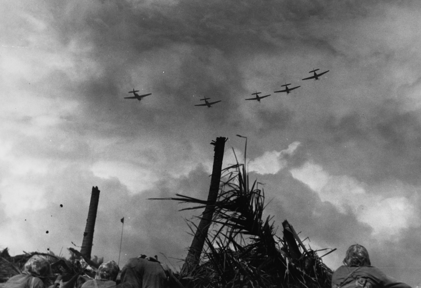TBF Avengers fly over U.S. Marine positions Battle of Kwajalein
