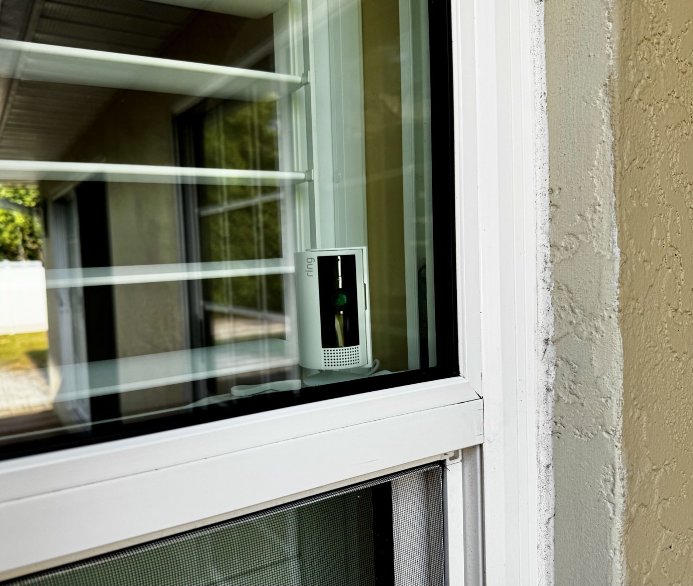The image displays a motion-activated camera mounted outside a home, angled to capture activity near entry points. This type of surveillance device is an important early warning system in home invasion prevention and response. It can detect movement and either send notifications to your phone or save footage for reviewing later. Having cameras like this around doors, windows, and other vulnerable areas increases your awareness of potential threats. Video monitoring not only helps you react faster if someone tries breaking in but also provides evidence for authorities in case of a crime. Integrating motion-activated cameras with alarms and other security tools is a key part of any comprehensive plan for how to survive a home invasion. Cameras also serve as a deterrent and are crucial for modern residential security.