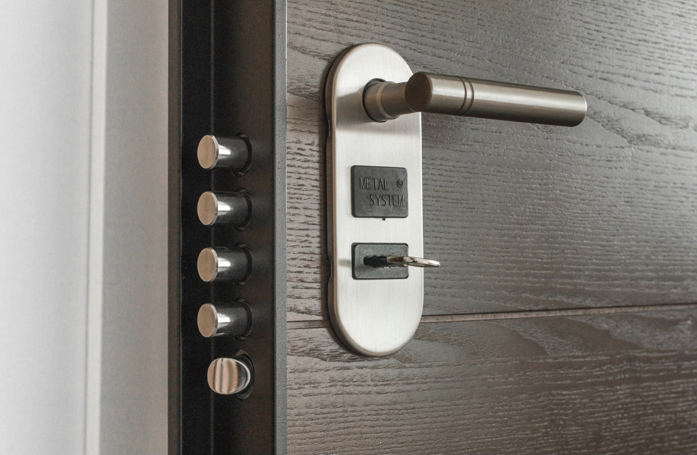 This photo shows a close-up of a reinforced door locking system, designed to make forced entry much more difficult for would-be intruders. Features might include a heavy-duty deadbolt, a reinforced strike plate, and upgraded mounting hardware, all critical elements for hardening a home’s entry points. Properly installed security locks and door frames are a basic but essential step in how to survive a home invasion, as most break-ins start with an attack on the front or back door. The reinforced system can resist kicking, prying, or even some hand tools used by criminals. Improving door security gives you more time to react, activate early warning systems, or call for help. Making your doors stronger can be one of the most effective first layers of home defense. This image represents a practical approach to burglary prevention and residential security.