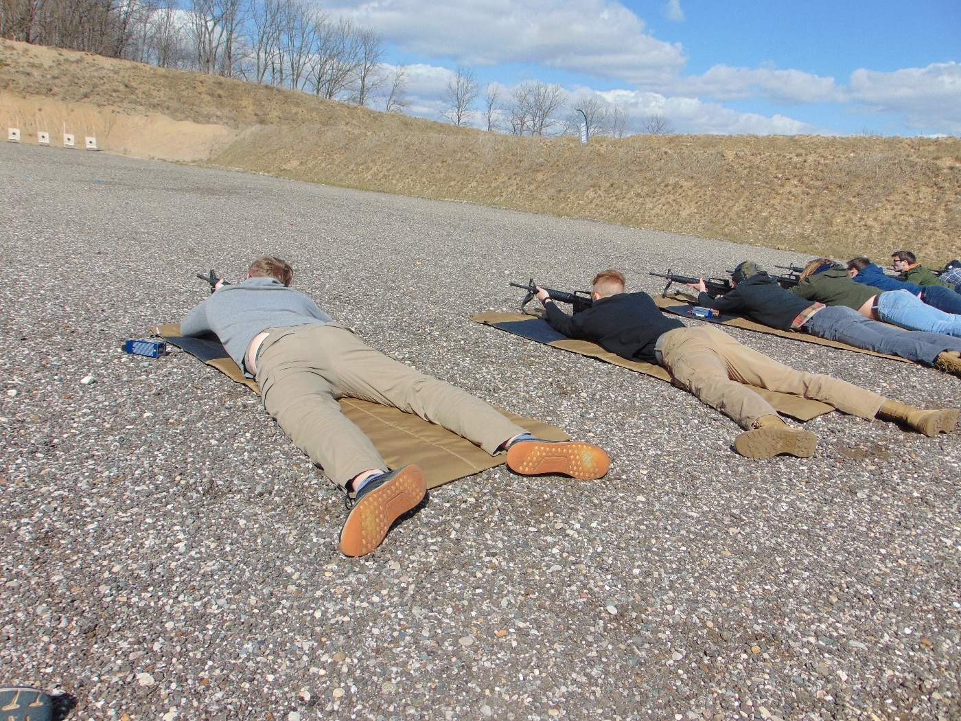 students at 50 yard line on shooting range with AR-15-style rifles
