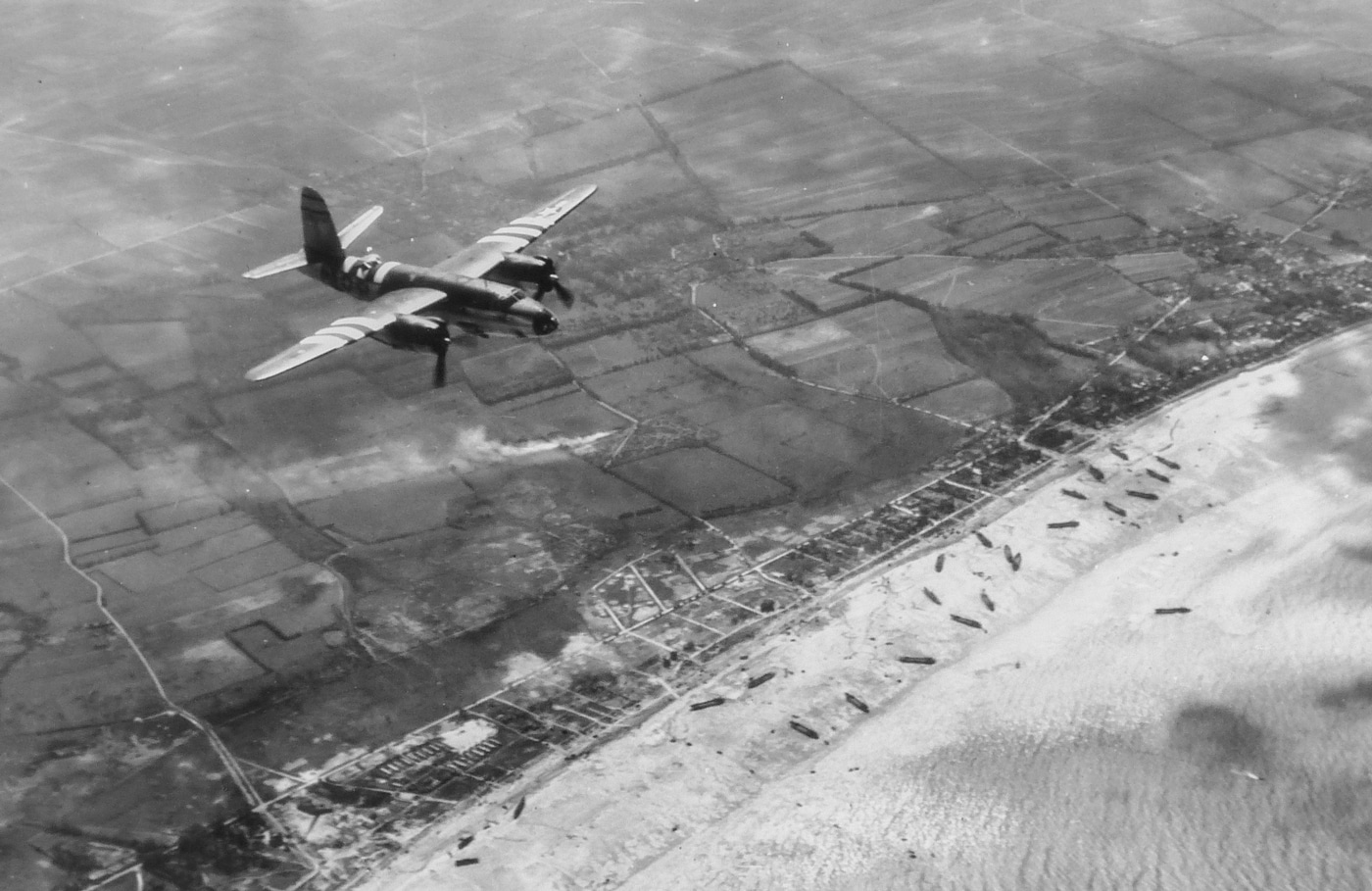 B-26 bomber flies over invasion beaches of France