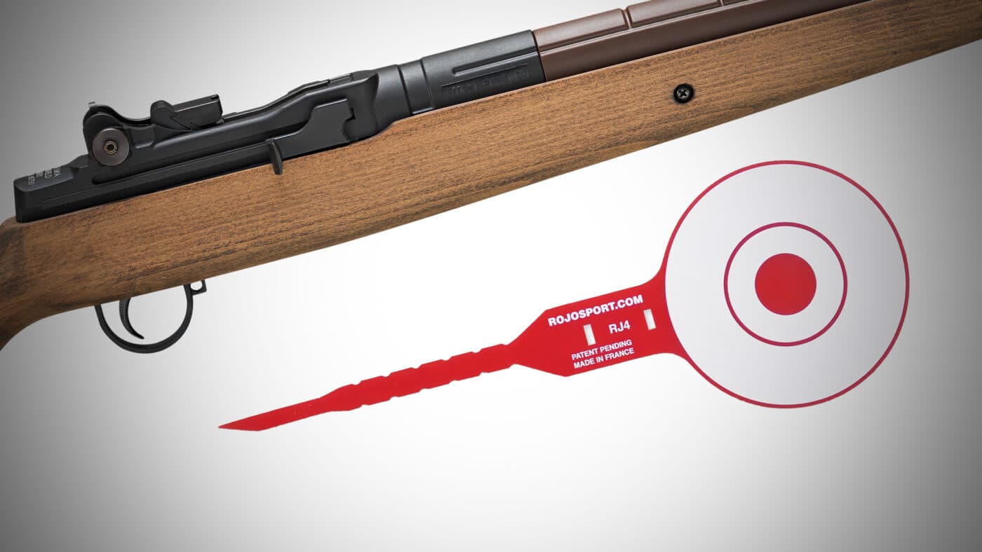 A Springfield Armory M1A underlever pellet rifle and a ROJO RJ4 Tactical Target are placed side by side on a plain white background. The rifle has a wooden stock and black metal barrel, and the tactical target is compact with a visible red bullseye and polyurethane build. Both products are clean and clearly visible, showing their features for a gear comparison. This image gives a good sense of the M1A’s realistic proportions and the portable size of the RJ4 target. Useful for readers wanting a clear look at both the air rifle and the target used in this Rojo RJ4 Tactical Target review.