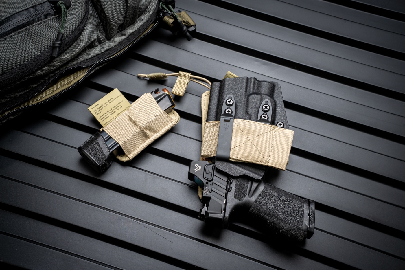 Photo showing the inside of the Viktos Upscale 3 Slingbag with a Springfield Armory pistol and spare magazine each secured in their own dedicated Viktos Velcro holders. The pistol is oriented for a quick right-handed draw, while the magazine sits in an adjacent elastic pouch. The holders use a hook-and-loop system to prevent movement and keep both the firearm and magazine accessible and organized. The bag’s interior is padded and lined for added protection. Zipper tracks, reinforced stitching, and the tough nylon exterior of the bag are also visible, reinforcing the emphasis on durability and daily usability. There are no other items present, keeping the focus on the firearm and magazine setup. This photo clearly demonstrates how the Viktos Upscale 3 is designed to support off-body concealed carry.