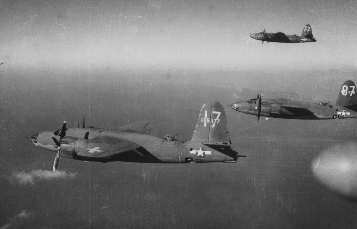 formation of B-26 Marauder bombers flying over German occupied territory