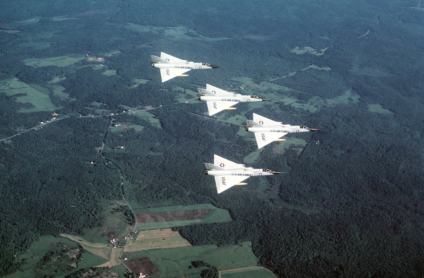 four F-106 Delta Dart interceptors in flight over New York