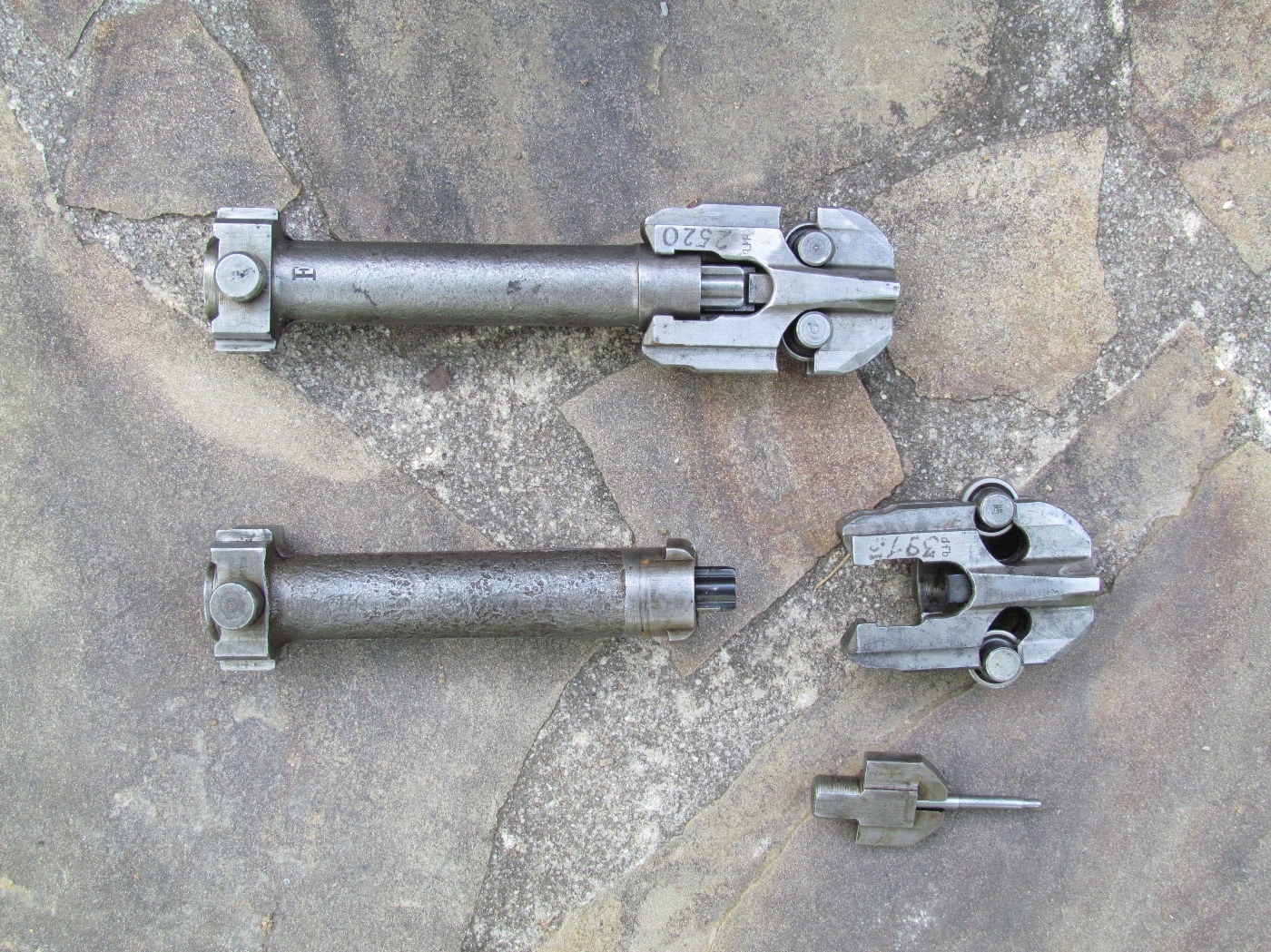 Close-up view of the MG 42 machine gun’s internal action, showing the roller-locked, recoil-driven mechanism that set the weapon apart from earlier designs. The image highlights key features such as the bolt, rollers, and camming surfaces that allow for rapid cycling and reliable function. Metal surfaces are visible, with machined and stamped parts in clear focus. This design was a major innovation, enabling the MG 42’s famously high rate of fire. The photo helps illustrate how the MG 42 machine gun operated at the mechanical level.