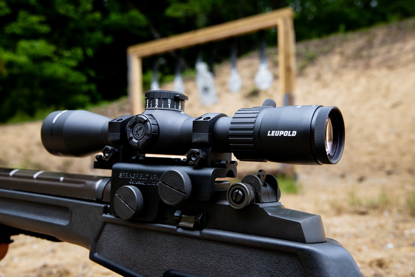 Photo showing the Leupold Mark 4HD 1.5-10x rifle scope securely mounted on an M1A rifle. The optic sits low and centered, demonstrating proper eye relief and alignment with the rifle’s action. The magnification ring, turrets, and throw lever are clearly visible, along with the scope’s robust mounting hardware. The combination of the Mark 4HD and M1A highlights the scope’s compatibility with classic semi-automatic rifles. This setup is ready for practical accuracy testing and field use.