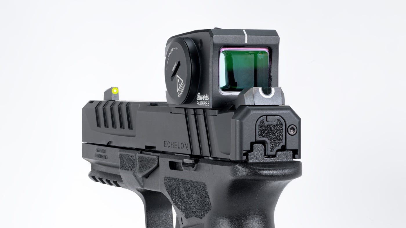 Photo shows a Burris FastFire E red dot sight securely mounted on the slide of a Springfield Echelon pistol. The optic’s fully enclosed design and robust 7075 aluminum housing are visible, emphasizing its durability. The fit appears precise, with no overhang or alignment issues, demonstrating compatibility with duty-style handguns. The Echelon’s iron sights are visible and co-witness through the optic’s window, supporting backup sight use. This image highlights the optic’s ruggedness and professional appearance. The background is neutral, keeping the focus on the pistol and mounted optic. The image would be useful for readers seeking information on mounting, construction, and duty use in a Burris FastFire E review.