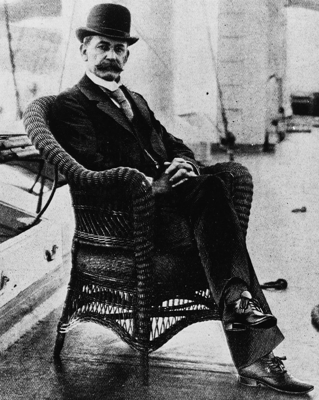 A historic black-and-white portrait of Captain Charles Dwight Sigsbee, United States Navy, taken around 1897 aboard USS Maine. He is dressed in a formal naval officer’s uniform with double-breasted buttons and shoulder insignia. His neatly groomed beard and confident posture reflect the authority of a senior naval commander. This photo shows him during his command of USS Maine, less than a year before the battleship exploded in Havana Harbor. Sigsbee’s composed leadership following the tragedy was widely noted at the time. He survived the explosion because his quarters were located toward the stern of the ship. The image provides a clear look at one of the most important naval figures connected to the Spanish-American War.