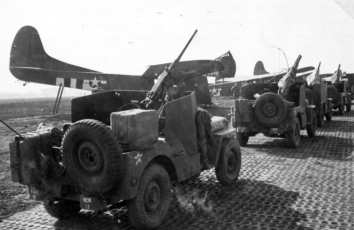 Jeeps armed with Browning 50 caliber machine guns load onto gliders for Operation Market Garden