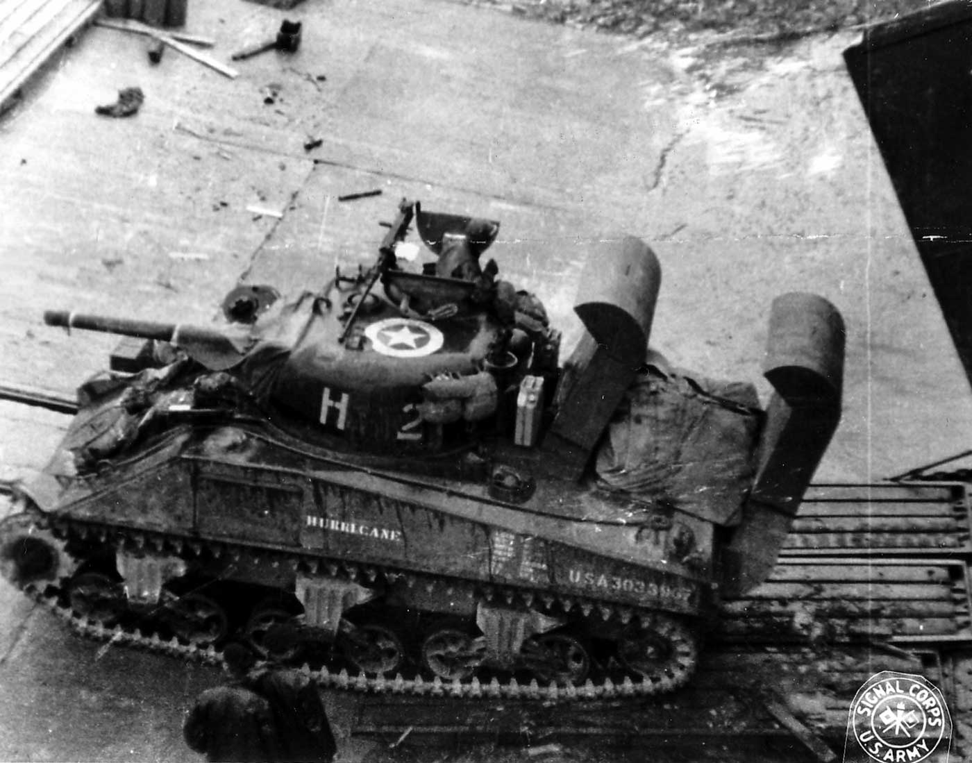 M4A3 Sherman tank with deep wading snorkels unloads from a landing ship on Utah Beach