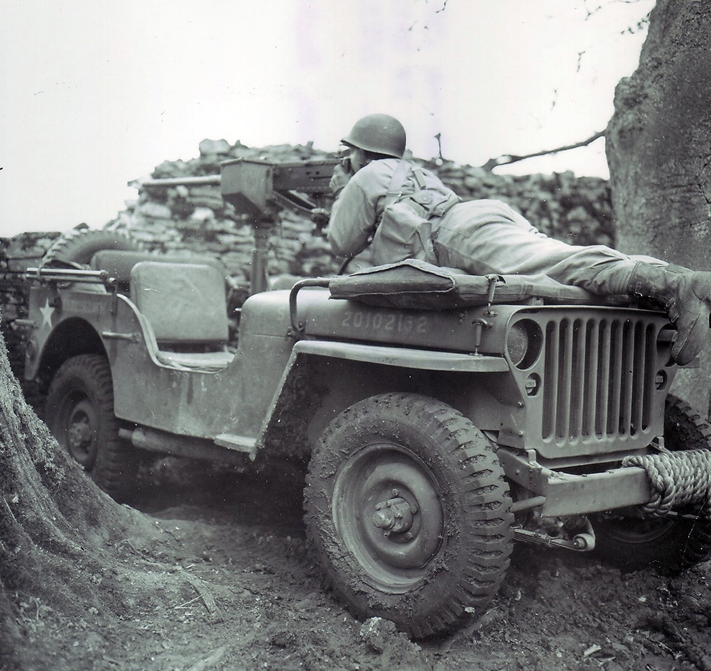 US soldier fires a 50 caliber machine gun from a Jeep