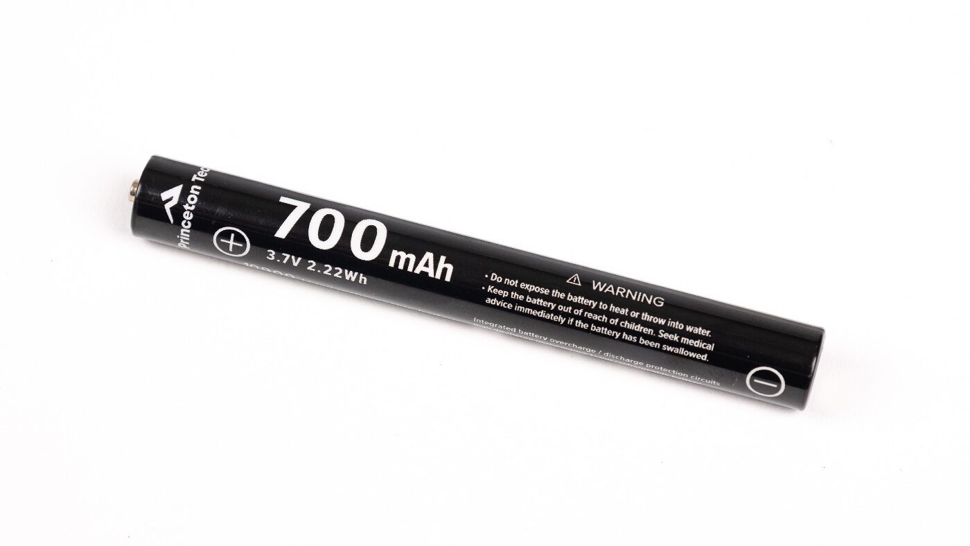 Image of the Princeton Tec 10900 rechargeable battery included with the Alloy-X flashlight. The cell is rated at 3.7 volts and 700 mAh capacity, designed specifically for the pen light. A USB-C charging port is built directly into the battery, allowing easy recharging without an external cradle or charger. The battery casing is labeled with Princeton Tec branding and specifications. This rechargeable option extends runtime and reduces the need for disposable batteries. It also gives the Alloy-X flexibility as part of its dual-fuel system, allowing users to switch to AAA cells if needed.