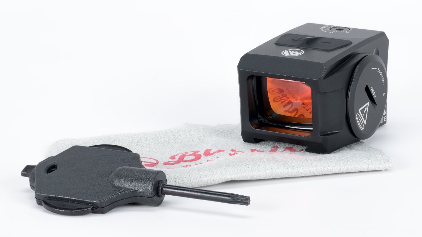 Photo displays the Burris FastFire E red dot optic and the included T10 Torx multi-tool arranged side by side on a plain background. The optic, with its enclosed design and robust build, is the main focus, while the Torx tool is clearly shown to the right or left of the sight. No other accessories are present, emphasizing that these are the two primary items included. The tool is recognizable by its distinctive T-handle or L-shape, designed for mounting and adjustment tasks. The optic’s battery compartment and mounting interface are visible. Lighting is bright and even, highlighting the texture and details of both items. This image is ideal for readers who want to know what’s in the box with the Burris FastFire E, specifically highlighting the optic and essential Torx tool.