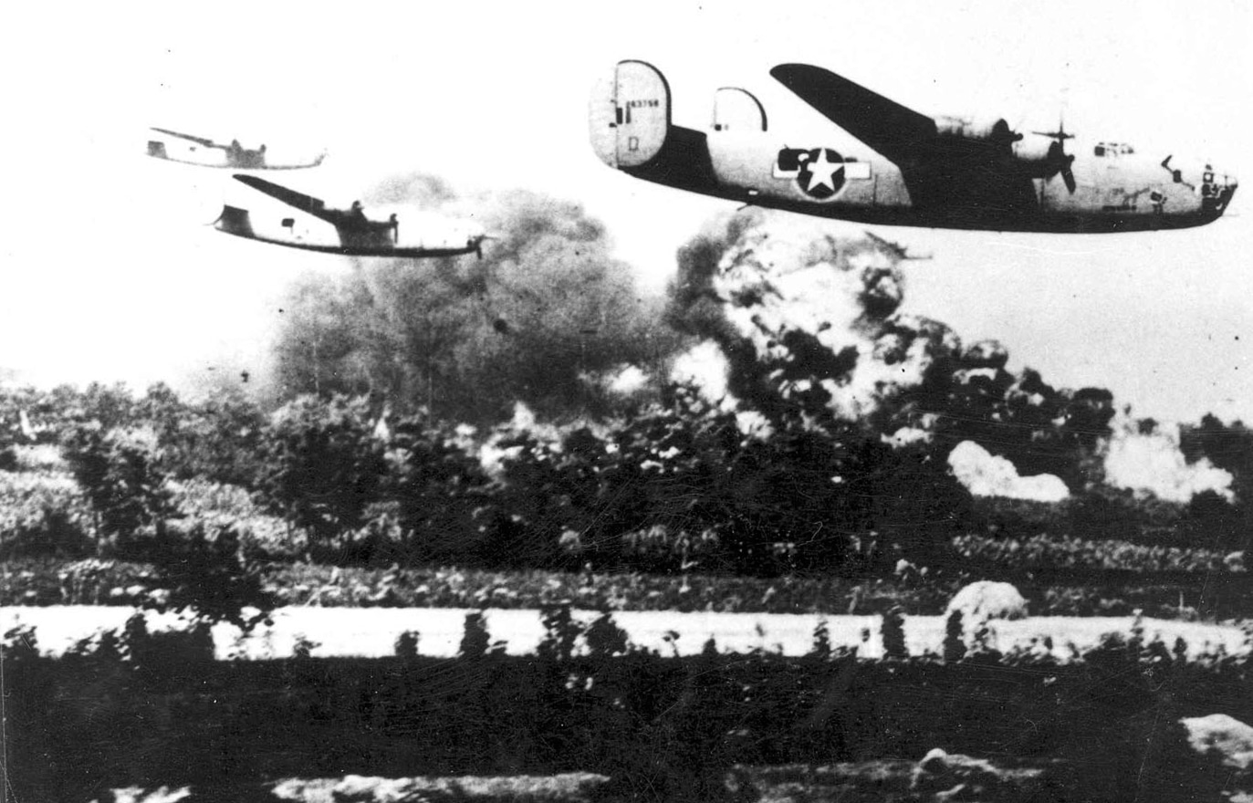 A formation of Consolidated B-24 Liberators is shown flying over the Ploesti oil refineries in Romania during Operation Tidal Wave, August 1, 1943. The bombers are captured in low-level flight, a tactic chosen to maximize bombing accuracy but one that exposed them to heavy anti-aircraft fire. Smoke and haze rise from the industrial complex below, evidence of the bombing runs. Nearly 180 B-24s participated in this mission, striking one of Germany’s most critical sources of fuel. The raid inflicted some damage but came at a terrible cost: 53 bombers were destroyed, and hundreds of aircrew were killed, captured, or interned. The photograph illustrates both the intensity and sacrifice of one of the most famous heavy bomber missions of World War II. It remains a defining moment in the Liberator’s combat history.