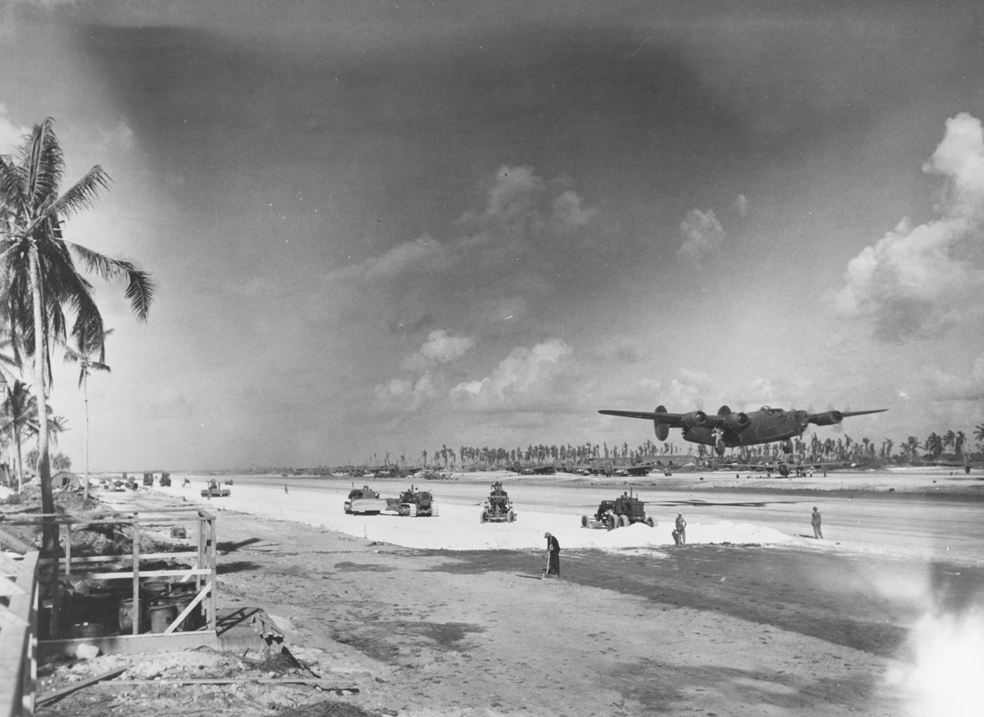 A U.S. Army Air Forces B-24 Liberator bomber is captured lifting off from a Pacific island runway ahead of the Mariana Islands campaign in World War II. The four-engine aircraft, with landing gear still extended, begins its climb into the sky under heavy load. Dust rises from the airstrip, a common sight on improvised coral and dirt runways used throughout the Pacific. The mission represents the long-range raids launched against Japanese strongholds to soften defenses before amphibious assaults. The B-24’s extended fuel capacity and range allowed it to operate effectively across vast stretches of ocean. This photo illustrates both the scale of Pacific operations and the critical role of strategic bombing. It captures the moment when aircrews committed to another dangerous mission over enemy territory.