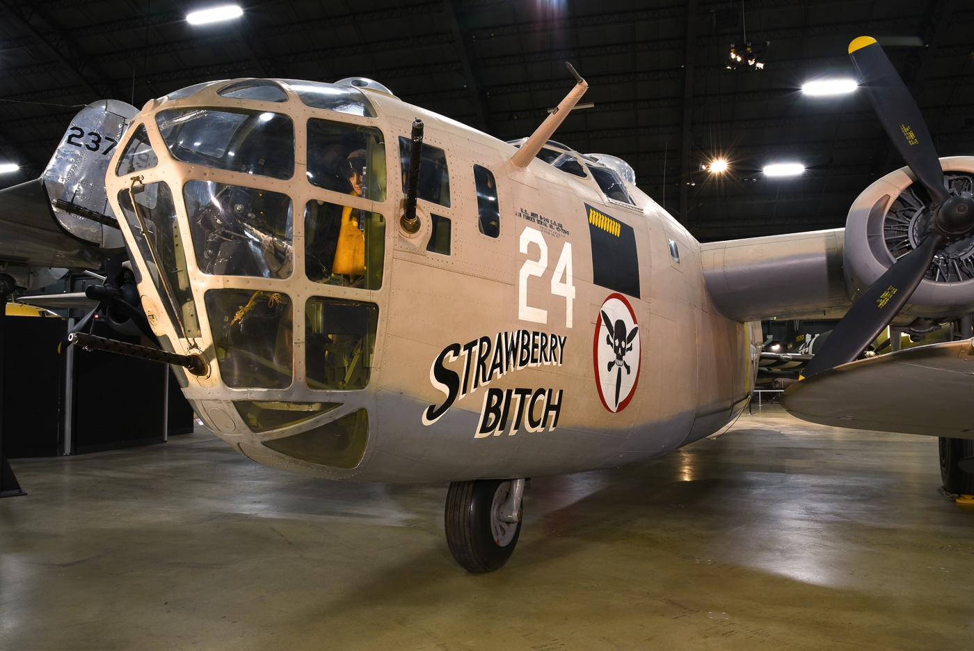 A Consolidated B-24 Liberator bomber is displayed at the National Museum of the United States Air Force in Dayton, Ohio. The restored aircraft is exhibited indoors, allowing visitors to view its large fuselage, high-mounted Davis wing, and distinctive twin tail assembly. The paint scheme and markings reflect its wartime appearance, honoring the thousands of bombers that served across Europe, the Pacific, and the Atlantic. This preserved Liberator provides a rare chance to see up close the complexity and size of the most-produced American bomber in history. Only a handful survive today, making this example especially significant. The museum exhibit highlights the engineering, history, and legacy of the B-24 in U.S. military aviation. It also serves as a tribute to the crews who flew dangerous missions during World War II.