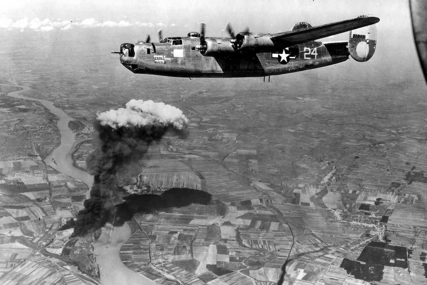 A North American-built Consolidated B-24G-16-NT Liberator, serial number 42-78471, nicknamed Fertile Myrtle, is shown during a mission with the 451st Bomb Group, 724th Bomb Squadron. The bomber belonged to the U.S. 15th Air Force, based in Italy, and is photographed during a raid over Hungary in World War II. The aircraft carries nose art identifying it by name, a common practice among bomber crews. Hungary was a frequent target due to its oil facilities, rail yards, and industrial support for Germany. The B-24G variant retained the long-range and heavy payload capability of earlier Liberators, making it suitable for deep strikes into Central Europe. This photo highlights both the individuality of combat aircraft through markings and the collective effort of the bomber groups. It represents the Liberator’s role in sustained strategic campaigns over Axis territory.