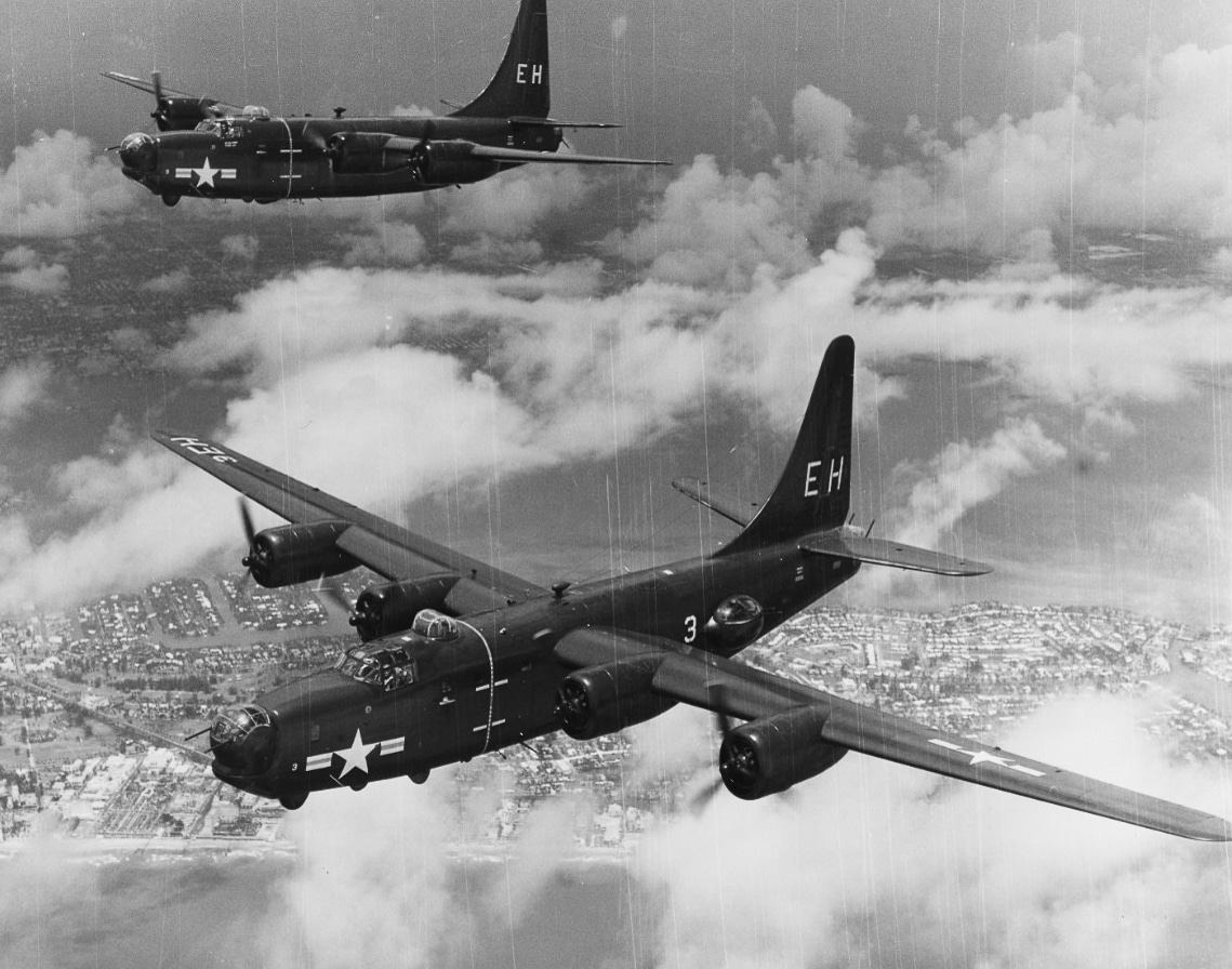A U.S. Navy Consolidated PB4Y-2 Privateer patrol bomber is photographed flying over Miami, Florida, in 1949. The aircraft, derived from the B-24 Liberator, features its distinctive single tall tail fin and lengthened fuselage. Below, parts of the city and coastline are visible, providing context for the aircraft’s flight over a postwar urban landscape. The PB4Y-2 served in naval patrol, anti-submarine warfare, and reconnaissance roles well into the late 1940s and 1950s. This variant carried radar, depth charges, and heavy armament during its service life, but by 1949 it was also being tested for peacetime roles such as weather reconnaissance. The photo demonstrates how military aircraft transitioned from combat service to new missions during the early Cold War. It also reflects the continuing utility of the Privateer in naval aviation history.
