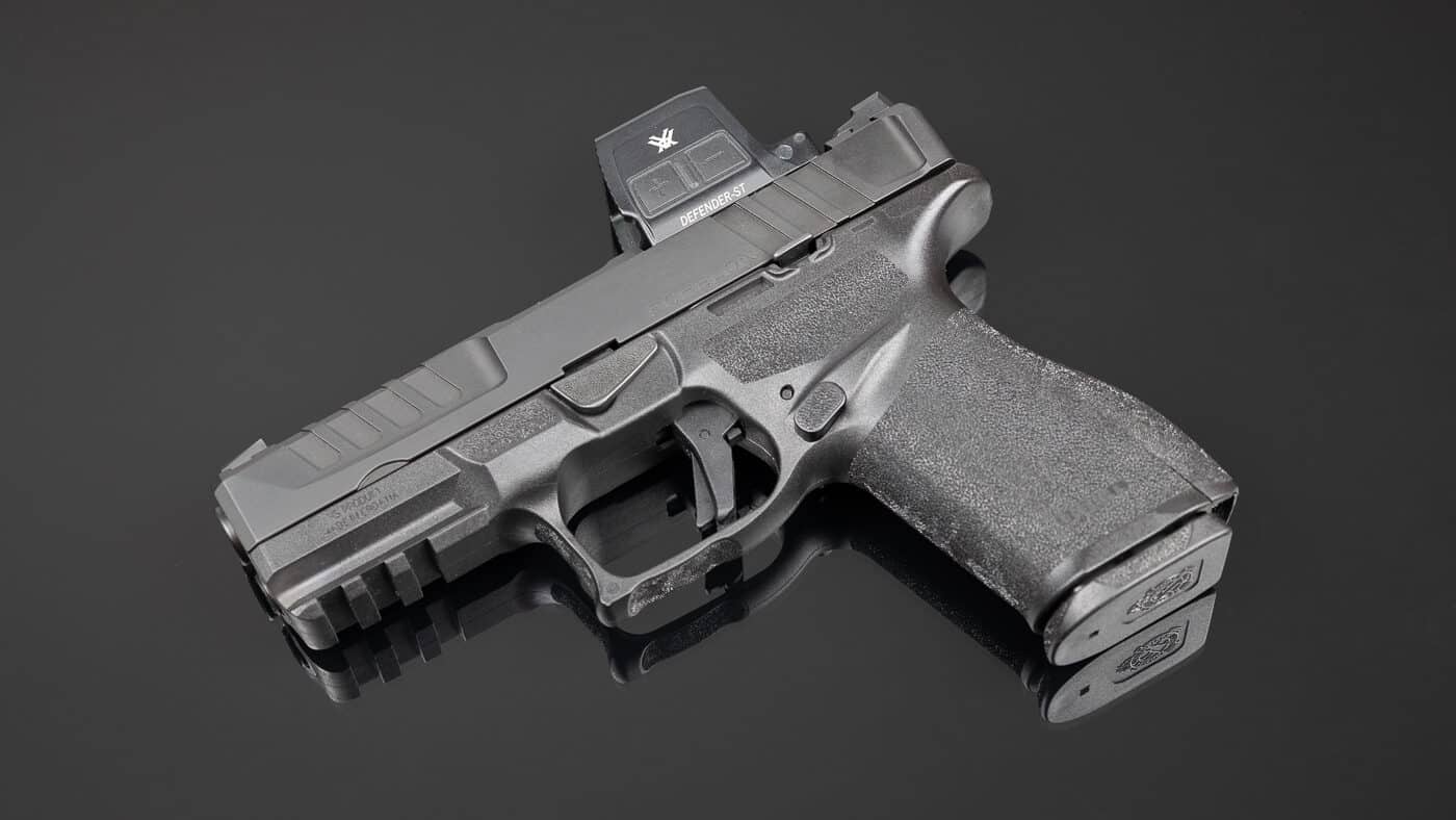 Side view of a Springfield Armory Echelon 4.0C pistol fitted with the Vortex Defender-ST Enclosed red dot sight. The optic is mounted directly to the slide using the DeltaPoint Pro footprint, requiring no adapter plate. The ST model is slightly larger than the CCW version, with a longer housing and a bigger viewing window that improves target acquisition speed. The rugged 7075 aluminum housing has Fast-Rack texturing on the front, allowing the shooter to manipulate the slide against hard surfaces. The enclosed emitter design keeps the LED protected from dirt, debris, and moisture. The photo shows how naturally the optic integrates with the full-size Echelon frame while maintaining a low-mounted profile.