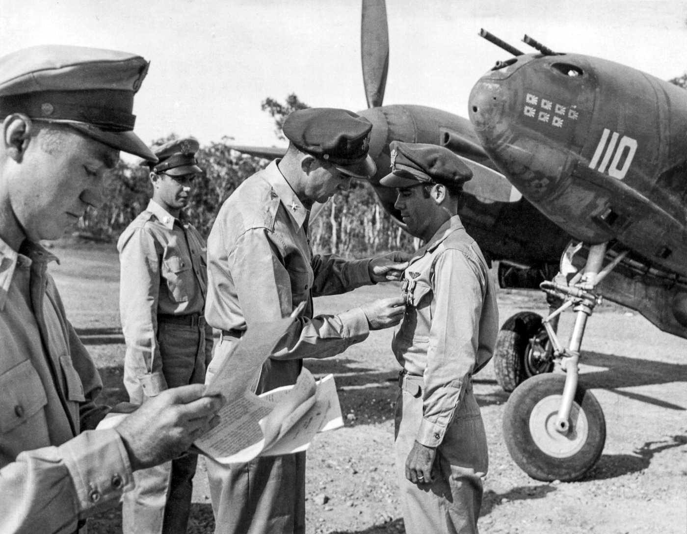 photograph showing Captain Thomas G. Lanphier, Jr. receiving the Distinguished Flying Cross and Silver Star after Operation Vengeance in 1943. Lanphier stands in uniform as he is presented with decorations recognizing his role in the interception of Admiral Yamamoto’s aircraft. The ceremony underscores how important the mission was to U.S. military leadership, both strategically and symbolically. Lanphier was one of the P-38 Lightning pilots who participated in the ambush over Bougainville. Although later historical reviews questioned his exact role in Yamamoto’s shootdown, he was publicly honored at the time. The photo captures the official recognition of one of World War II’s most famous aerial missions.