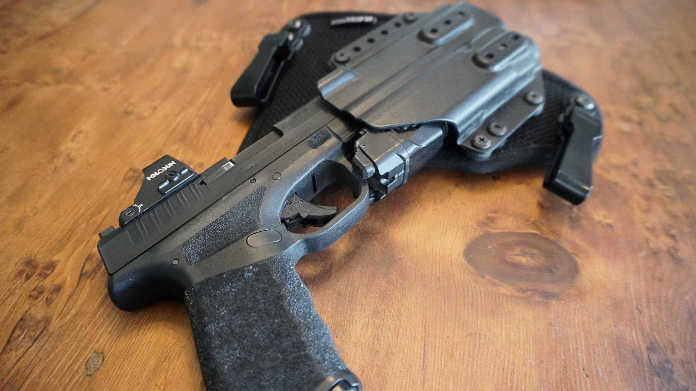 Close-up photo of the Kydex shell used in the StealthGearUSA Ventcore 2.0 IWB Mini holster. The black Kydex material is thick and molded precisely to match the contours of the firearm. Edges are rounded off slightly to avoid sharp corners that could dig into clothing or skin. The clean molding helps provide reliable firearm retention and long-term durability. Small hardware attachment points are visible, part of the holster’s modular design. The photo emphasizes quality construction and attention to detail in the shell. This component is key to how the holster maintains shape and function.