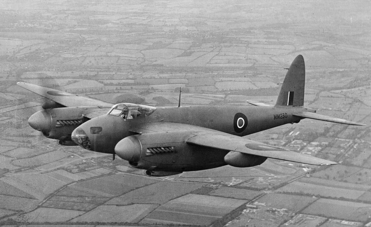 A de Havilland Mosquito PR Mk IX, serial number MM230, captured in flight shortly after completion at the company’s Hatfield works in Hertfordshire. The aircraft is seen in midair, showcasing its long wings and streamlined fuselage designed for high-speed reconnaissance. Originally intended for photographic missions, the PR IX carried cameras instead of heavy armament, relying on speed for defense. MM230 served with the RAF’s Fighter Interception Unit before being returned to de Havilland Ltd for trials and display purposes. The photo highlights the clean finish and aerodynamic efficiency of the Mosquito design. With its Merlin engines and lightweight wooden structure, it was among the fastest aircraft of its time. The image reflects both the operational and developmental roles played by this particular Mosquito.